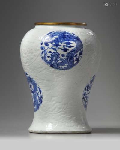 A RARE CHINESE MOULDED WHITE-GROUND BLUE AND WHITE 'DRAGON' VASE
