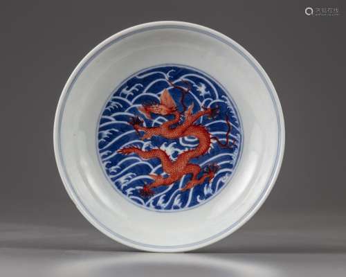 A CHINESE IRON-RED-DECORATED BLUE AND WHITE 'DRAGON' DISH