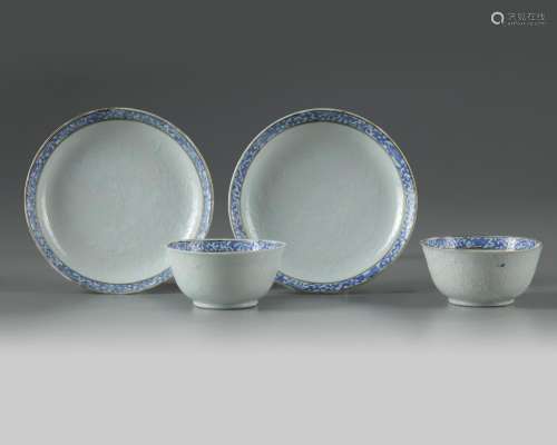 A PAIR OF CHINESE BIANCO SOPRA BIANCO-DECORATED CUPS AND SAUCERS