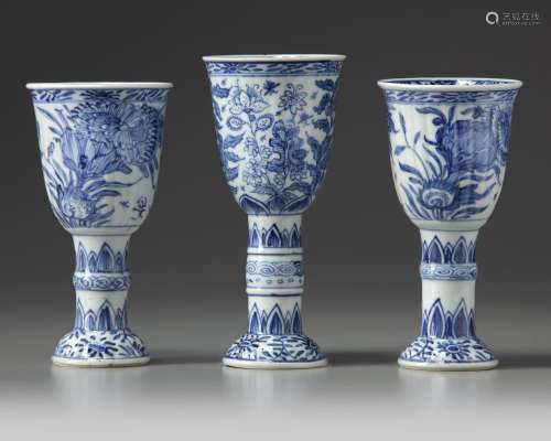 THREE CHINESE BLUE AND WHITE STEMMED BEAKERS