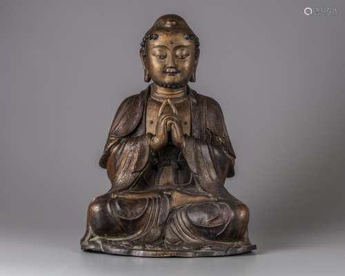 A CHINESE PARCEL-GILT BRONZE FIGURE OF A MONK