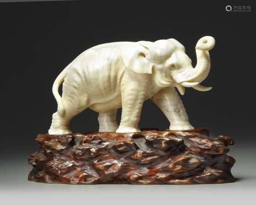 AN IVORY ELEPHANT ON A WOODEN STAND