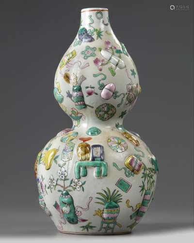 A CHINESE FAMILLE ROSE MOULDED DOUBLE GOURD VASE