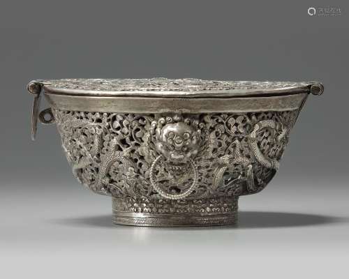 A TIBETAN SILVER TEA BOWL CONTAINER AND HINGED COVER