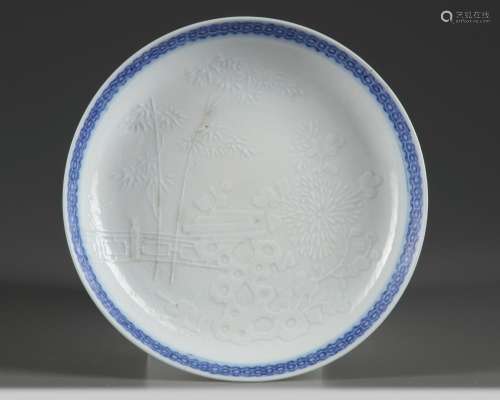 A MOULDED CHINESE BLUE AND WHITE DISH