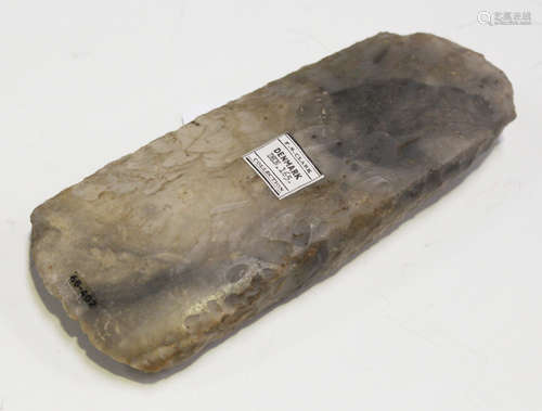 A Danish Stone Age part-polished flint axe head, bearing 'F.S. Clark Denmark Collection' label and