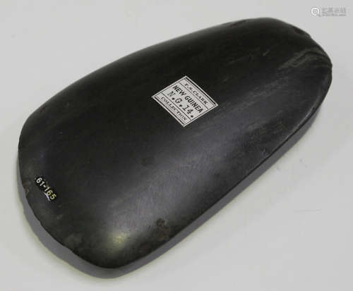 A New Guinea polished green stone axe head, bearing 'F.S. Clark New Guinea Collection' label and