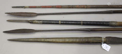 A group of three African spears, one with a horn tip, together with a Papua New Guinea spear and a