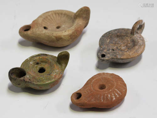 A group of four mainly Ancient Roman terracotta oil lamps, all circa 2nd-4th century AD, one example