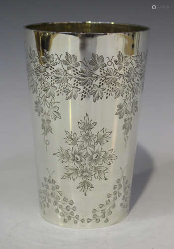 A Victorian silver beaker of tapering cylindrical form, engraved with a fruiting vine garland and