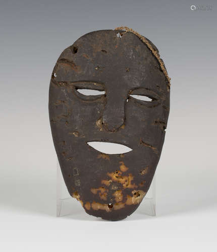 A late 19th/early 20th century African carved elephant hide mask, probably Lega people, Democratic