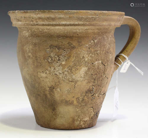 A Medieval brown glazed earthenware jar, circa 1450 AD, the slightly shaped ovoid body with a