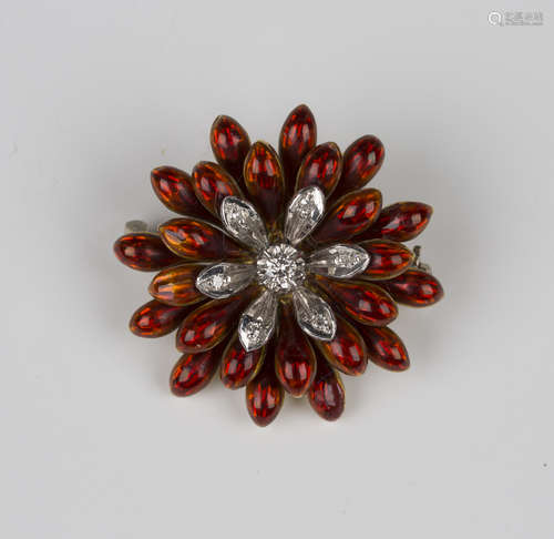 A gold, diamond and red enamelled brooch, designed as a flowerhead, mounted with seven circular