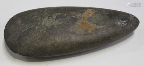 A large ancient polished stone axe head of pear shaped form, detailed 'W. Indies' in white ink,