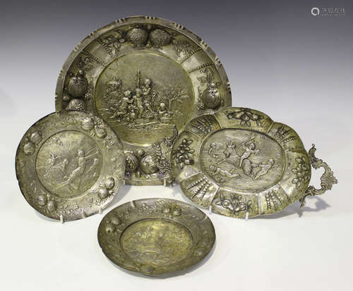 A pair of late 19th century German silver circular dishes, each decorated in relief with classical