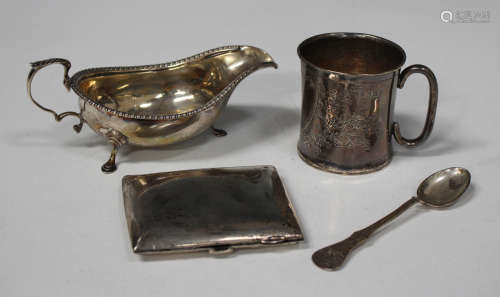 A George III silver sauce boat with foliate capped scroll handle and gadrooned rim, on scroll