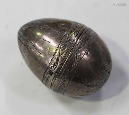 An early 19th century Continental silver nutmeg grater of ovoid form with engraved decoration, the