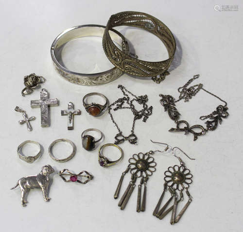 A group of silver and other jewellery, comprising an oval hinged bangle, the front with scroll