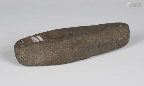 A Scandinavian Stone Age pecked stone boat shaped axe head with part-perforation, bearing 'F.S.