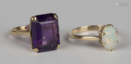 A gold ring, claw set with a cut cornered rectangular step cut amethyst, detailed '9ct', ring size