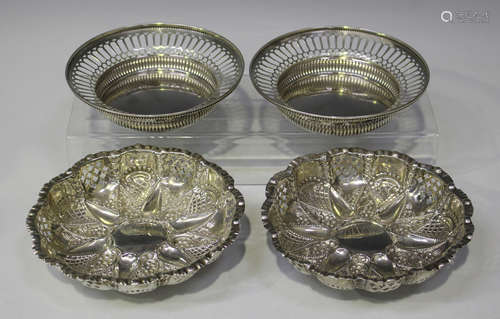 A pair of late Victorian silver circular lobed dishes with pierced and foliate embossed