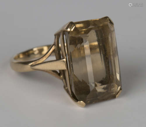 A gold ring, claw set with a cut-cornered rectangular step cut citrine, ring size approx O1/2.