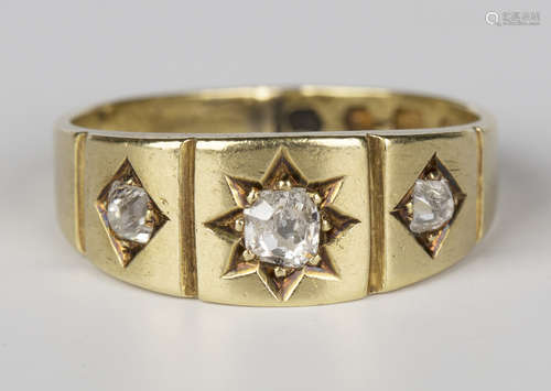 A Victorian 18ct gold and diamond three stone ring, mounted with cushion shaped diamonds within