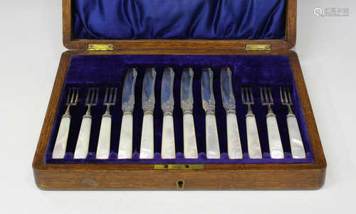 A set of six Edwardian silver fish knives and forks with engraved decoration and mother-of-pearl