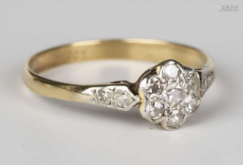 A gold and diamond seven stone cluster ring, mounted with circular cut diamonds between diamond