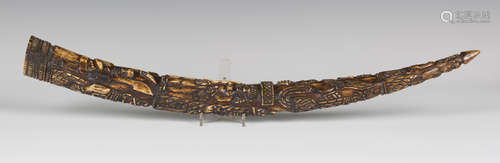 A 19th century Benin carved ivory tusk, profusely worked with bands of warriors, length 56cm.Buyer’s