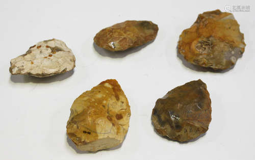 A group of five British Palaeolithic flint hand axes, each with ink written details, including '