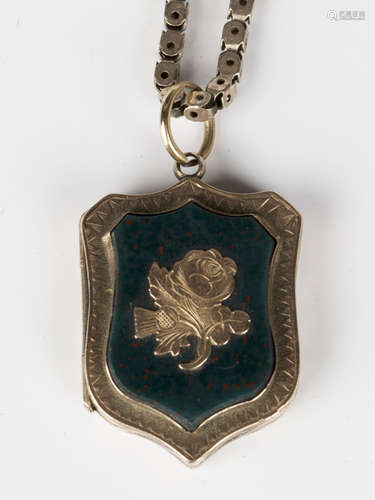 A Victorian bloodstone set shield shaped pendant locket, the front decorated with a spray