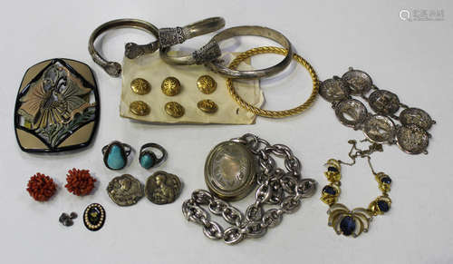 A group of jewellery, comprising three bangles, a bracelet, an oval pendant locket with an anchor