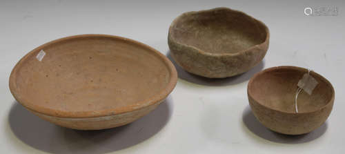 Two Ancient Roman pale terracotta bowls, diameters 21.5cm and 11cm, together with a Holy Land