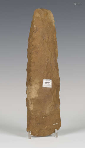 A large Danish Stone Age brown flint axe head of overall flaked and shaped expanding form,