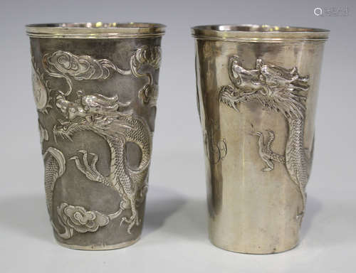 An early 20th century Chinese silver beaker of cylindrical tapering form, decorated in relief with