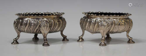 A pair of George III silver oval salts, each with gadrooned rim above a reeded body, raised on