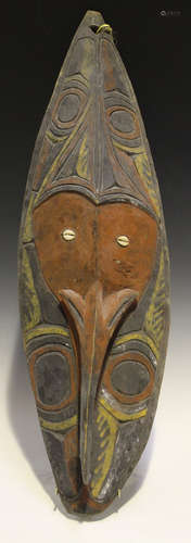 A Papua New Guinea carved wooden tribal mask, Sepik River Region, the surface with natural