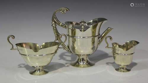 A Victorian silver bachelor's three-piece tea set of 'U' shape with girdle on a circular foot,