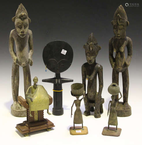 An Ashanti Akan Aku'ba fertility figure, height 30cm, three other carved wooden figures and three