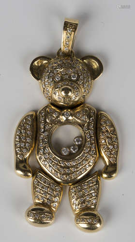 A gold and diamond pendant, designed as an articulated teddy bear, mounted with circular cut