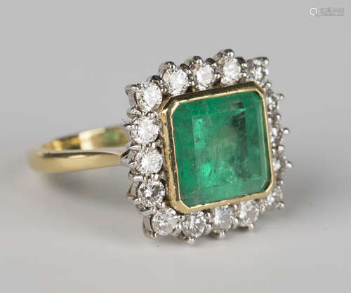 An 18ct gold, emerald and diamond square cluster ring, mounted with a square cut emerald in a