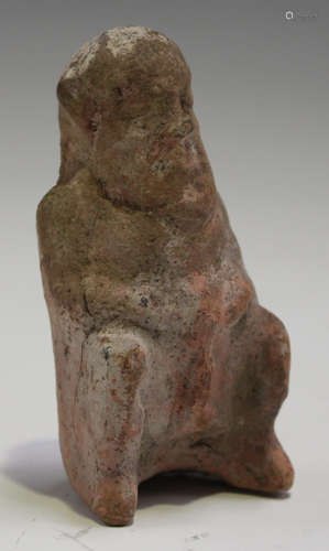 An Ancient Greek Boeotian pink terracotta figure of a satyr, 5th century BC, the squatting figure