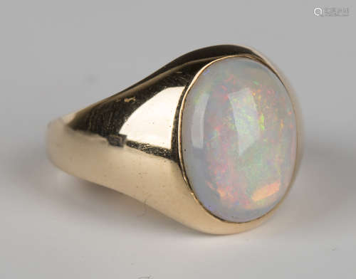 A gold ring, mounted with an oval opal, ring size approx M1/2, with a box.Buyer’s Premium 29.4% (