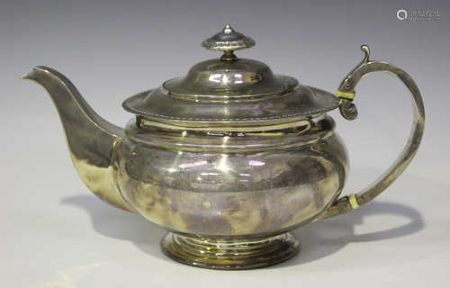 A George III Scottish silver circular teapot with gadrooned rim and loop handle, on a circular foot,