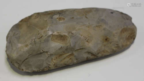 A small Neolithic chipped and part-polished axe head, detailed in black ink 'Thames Valley partly