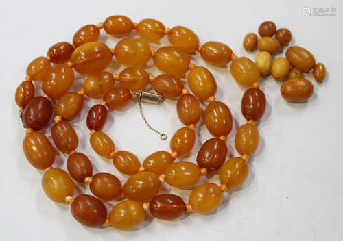 A single row necklace of forty-two graduated oval vari-coloured opaque and semi-translucent