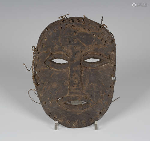 A late 19th/early 20th century African carved elephant hide mask, probably Lega people, Democratic