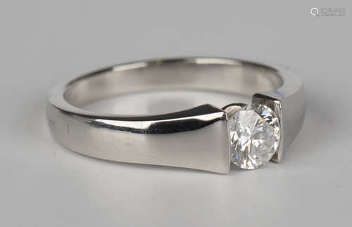 A platinum and diamond single stone ring, mounted with a circular cut diamond, detailed 'Plat', ring