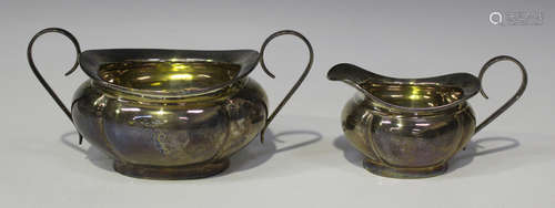 A George V silver two-handled sugar bowl and matching milk jug of lobed oval form, Birmingham 1925